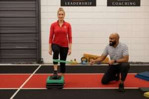 Active adult doing a step-up while working through knee pain with step-ups