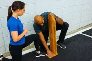 Runner holding the outer knee from IT band syndrome pain
