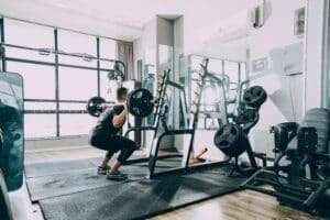 Active adult doing squats for knee pain to build strength and protect the knees