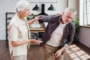 Active adult deciding whether to push through pain or stop during a workout
