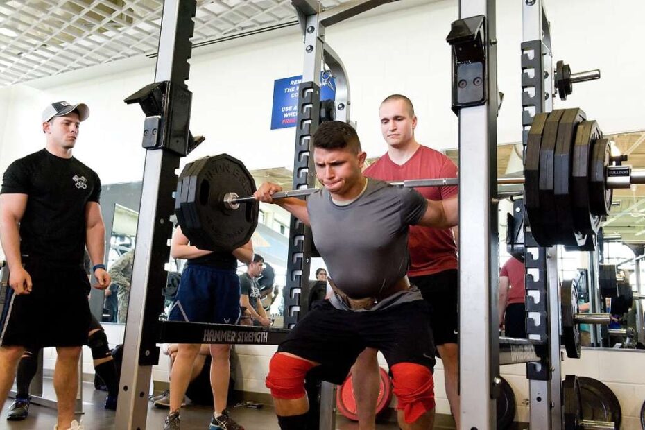 Squat barbell hurts neck during a heavy back squat with the bar resting high on the upper back.